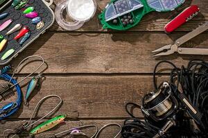 Accessories for fishing on the background of wood. Top view photo