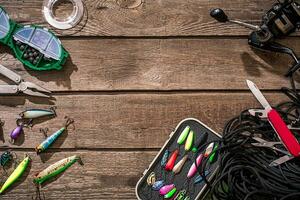 Accessories for fishing on the background of wood. Top view photo