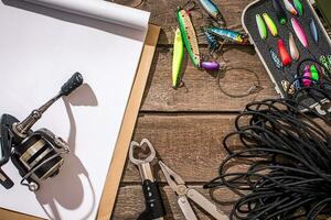 Accessories for fishing on the background of wood. Top view photo