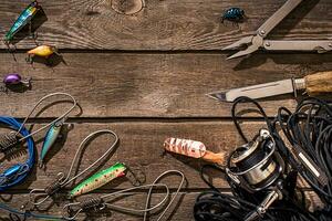 Accessories for fishing on the background of wood. Top view photo