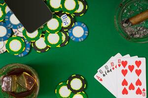 Set to playing poker with cards and chips on green table, top view photo