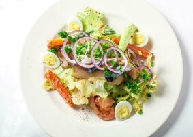 Salad with mackerel fish, zucchini, lettuce, carrots and creamy dressing photo