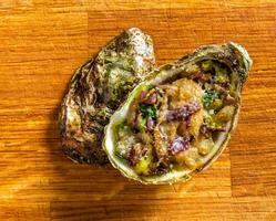 Salad in oyster on a wooden background. photo