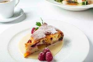 Piece of delicious clafoutis with nectarine and plum photo