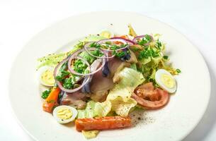 Salad with mackerel fish, zucchini, lettuce, carrots and creamy dressing photo