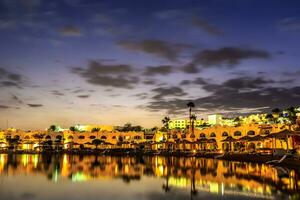 Evening view from sea for luxury hotel in night illumination photo