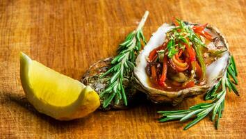 Salad in oyster served with greens and lemon photo