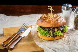 Burger on the table with devices photo