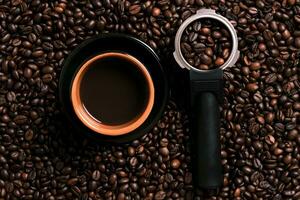 A cup of black coffee with coffee bean as background photo