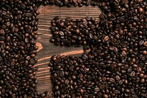 Letter F inscription with coffee bean on the wooden table photo