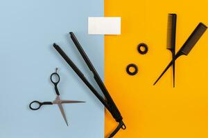 Hairdresser set with various accessories on orange and blue background photo