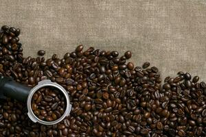 Coffee beans on burlap background. photo