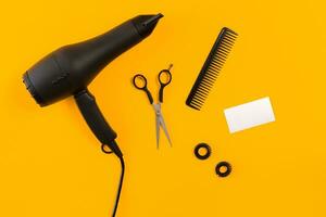 Hairdresser set with various accessories on orange and blue background photo