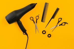 Hairdresser set with various accessories on orange and blue background photo