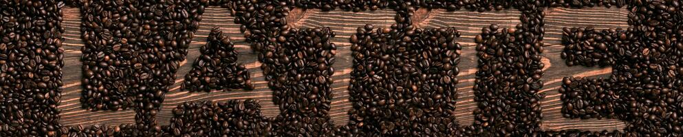 Latte word written with wooden letters on coffee beans heap photo