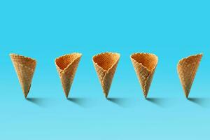 Ice cream cones pattern. Turquoise background. Sweet, summer and empty concept. photo