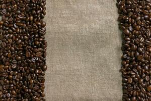 Coffee beans on burlap background. photo