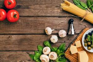 Italian food background with pasta, spices and vegetables. Top view, copy space. photo