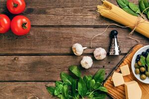 Italian food background with pasta, spices and vegetables. Top view, copy space. photo