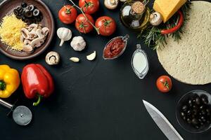 Pizza cooking ingredients. Dough, vegetables and spices. Top view with copy space photo