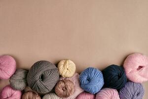 Set of colorful wool yarn on beige background. Top view photo