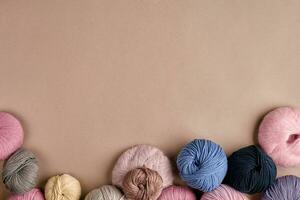 Set of colorful wool yarn on beige background. Top view photo