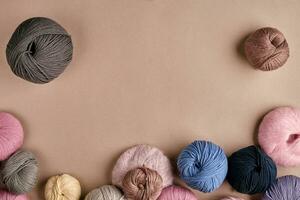 Set of colorful wool yarn on beige background. Top view photo