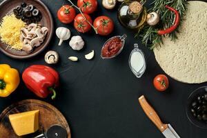 Pizza cooking ingredients. Dough, vegetables and spices. Top view with copy space photo