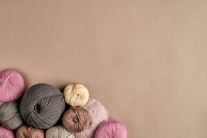 Set of colorful wool yarn on beige background. Top view photo