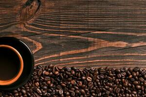 Coffee cup and beans frame on wooden table photo