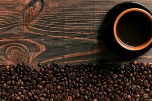 Coffee cup and beans frame on wooden table photo