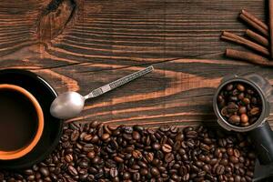 Coffee cup and beans frame on wooden table photo