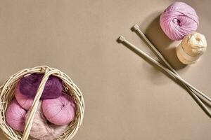 Balls of woolen threads and knitting needles. Scandinavian style. Threads for knitting in a basket. photo