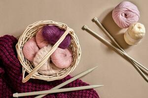 Balls of woolen threads and knitting needles. Scandinavian style. Threads for knitting in a basket. photo