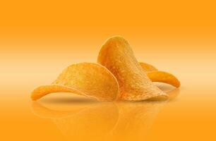 Potato crisps on a yellow background with copy space for text or images, mirror surface. Advertising concept. Close-up shot. photo