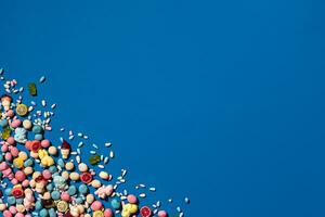 Photo of candies dragee placed on the corner of image with a copy space in the middle