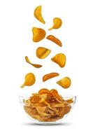 Potato crisps falling down in glass bowl, isolated on white background with copy space for text, images. Crispy chips. Advertising. Close-up. photo