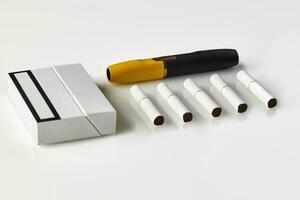 New generation black and yellow electronic cigarette, pack and five heatsticks, isolated on white. New technology. Advertising area. Close up photo