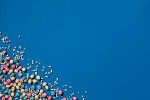 Photo of candies dragee placed on the corner of image with a copy space in the middle
