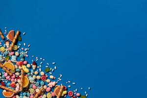 Photo of candies dragee placed on the corner of image with a copy space in the middle