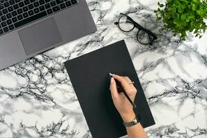 Top view in focus with different office equipment, supplies, stationery. Marble table with copy space. Education, workplace background. Close-up. photo