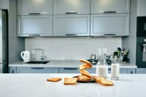 Served table for breakfast with toast, milk and honey, on blurred background photo