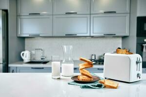 Served table for breakfast with toast, milk and honey, on blurred background photo