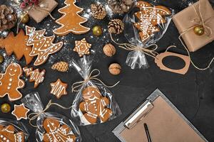 Christmas background with gingerbread cookies and craft sheets of paper. Copy space. photo