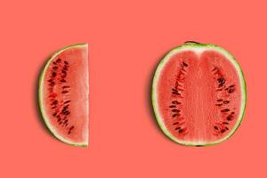 Green, striped watermelon, pink background with copy space for text, images. Cross-section. Berry with red flesh, black seeds. Top view. Close-up. photo