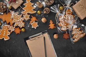 Christmas background with gingerbread cookies and craft sheets of paper. Copy space. photo