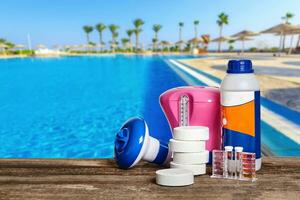 Equipment with chemical cleaning products and tools for the maintenance of the swimming pool. photo