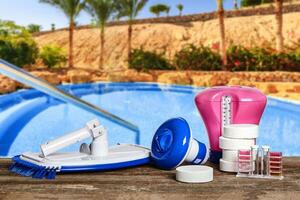 Equipment with chemical cleaning products and tools for the maintenance of the swimming pool. photo