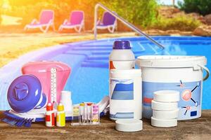 Equipment with chemical cleaning products and tools for the maintenance of the swimming pool. photo