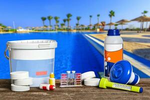 Equipment with chemical cleaning products and tools for the maintenance of the swimming pool. photo